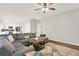 Bright living room showcases a comfortable gray sectional couch and open concept kitchen at 224 Mountain View Dr, Woodstock, GA 30188