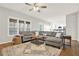 Bright living room featuring a comfortable gray sectional couch and an adjacent open concept kitchen at 224 Mountain View Dr, Woodstock, GA 30188