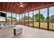 Relaxing screened-in porch with wood floors, ceiling fan, and outdoor furniture at 224 Mountain View Dr, Woodstock, GA 30188