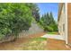 Backyard view showing retaining wall, ground cover, concrete pad and home exterior at 5865 Trailwood Ct, Suwanee, GA 30024