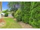 View of the backyard featuring well manicured trees and landscaping at 5865 Trailwood Ct, Suwanee, GA 30024