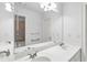 Bright bathroom featuring double sinks, a large mirror, and a neutral color palette at 5865 Trailwood Ct, Suwanee, GA 30024