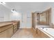 Bathroom featuring double vanity sinks, soaking tub, glass shower, and tiled flooring at 5865 Trailwood Ct, Suwanee, GA 30024