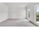 Bright bedroom with two windows, neutral carpet, and fresh white paint at 5865 Trailwood Ct, Suwanee, GA 30024
