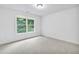 Neutral bedroom with large window showing treed backyard, offering ample light at 5865 Trailwood Ct, Suwanee, GA 30024