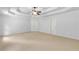 Carpeted bedroom features a tray ceiling, ceiling fan and two closets, and neutral walls at 5865 Trailwood Ct, Suwanee, GA 30024