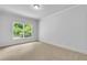 Bright bedroom with neutral carpet, ample natural light from the large window, and modern trim at 5865 Trailwood Ct, Suwanee, GA 30024