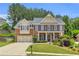 Charming two-story brick home features a manicured front yard, attached garage, and classic architectural details at 5865 Trailwood Ct, Suwanee, GA 30024