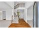 Bright foyer with hardwood floors, staircase and a view of the upper level landing at 5865 Trailwood Ct, Suwanee, GA 30024