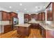 Modern kitchen featuring granite countertops, stainless steel appliances, a kitchen island and wooden cabinets at 5865 Trailwood Ct, Suwanee, GA 30024