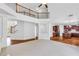 Open floor plan with living room and kitchen featuring a staircase leading to the upper level at 5865 Trailwood Ct, Suwanee, GA 30024