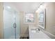 Bathroom featuring a glass-enclosed shower, modern vanity, and a window for natural light at 1890 Carla Dr, Morrow, GA 30260