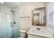 The renovated bathroom features a walk-in shower with glass door and modern vanity at 1890 Carla Dr, Morrow, GA 30260
