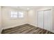 A cozy bedroom features modern floors, fresh paint, a ceiling fan, and a closet for ample storage at 1890 Carla Dr, Morrow, GA 30260