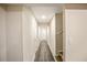 Well-lit hallway with wood-look flooring, light beige walls, and an open doorway at 1890 Carla Dr, Morrow, GA 30260