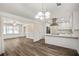 Open concept living space connecting kitchen and living room with hardwood floors and modern finishes at 1890 Carla Dr, Morrow, GA 30260