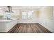 Bright kitchen and dining nook featuring stylish floors, modern appliances, and white cabinets at 1890 Carla Dr, Morrow, GA 30260