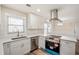 A modern kitchen features white cabinets, stainless steel appliances, and an adjacent dining area at 1890 Carla Dr, Morrow, GA 30260