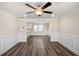 Elegant living room featuring neutral paint, white trim, dark wood-look floors, and ceiling fan at 1890 Carla Dr, Morrow, GA 30260