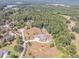Expansive aerial view of a grand home on a vast lot surrounded by trees, with lake and tennis courts at 2740 Bountiful Pl, Lawrenceville, GA 30045