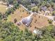 Aerial view of a house with a tennis court, surrounded by trees and a long driveway at 2740 Bountiful Pl, Lawrenceville, GA 30045