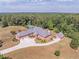 Sweeping aerial view of an estate with a circular driveway, multiple garages, and beautiful landscaped grounds at 2740 Bountiful Pl, Lawrenceville, GA 30045