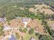 Picturesque aerial view of a beautiful home and lush landscaped property with a tennis court, a private oasis at 2740 Bountiful Pl, Lawrenceville, GA 30045
