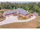 Dramatic aerial shot of a brick estate featuring multiple garages, long driveway and manicured landscaping at 2740 Bountiful Pl, Lawrenceville, GA 30045