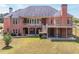 Brick home with a walkout basement, outdoor living area, balcony, and lush green lawn at 2740 Bountiful Pl, Lawrenceville, GA 30045