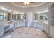 Elegant bathroom with multiple vanities, decorative mirrors, tile floors, and custom cabinetry, offering ample space at 2740 Bountiful Pl, Lawrenceville, GA 30045