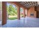Covered patio showcasing brick columns, fireplace, and polished floors for a cozy outdoor living area at 2740 Bountiful Pl, Lawrenceville, GA 30045