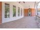 Expansive covered patio with curved windows, brick accents, and tranquil backyard views at 2740 Bountiful Pl, Lawrenceville, GA 30045