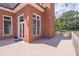 Outdoor patio features brick exterior with french door access, natural lighting and view of the backyard at 2740 Bountiful Pl, Lawrenceville, GA 30045