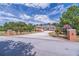 Well-manicured lawn and brick pillars leading to a stately brick home with circular driveway at 2740 Bountiful Pl, Lawrenceville, GA 30045