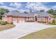 Stately brick home with a three-car garage and circular driveway at 2740 Bountiful Pl, Lawrenceville, GA 30045