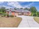 Expansive brick home with a three-car garage, circular driveway, and manicured lawn at 2740 Bountiful Pl, Lawrenceville, GA 30045