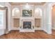 Elegant fireplace with custom built-ins, arched accents, and hardwood floors, adding warmth and sophistication at 2740 Bountiful Pl, Lawrenceville, GA 30045