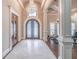 Elegant foyer with marble floors, chandelier, and arched doorway, showcasing sophisticated design and architectural details at 2740 Bountiful Pl, Lawrenceville, GA 30045