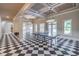 Spacious game room featuring checkerboard flooring, multiple windows, and stylish lighting at 2740 Bountiful Pl, Lawrenceville, GA 30045