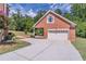 Detached brick garage with white doors, concrete driveway, and manicured landscaping at 2740 Bountiful Pl, Lawrenceville, GA 30045