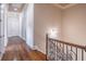 Upstairs hallway with decorative wrought iron railing and hardwood floors at 2740 Bountiful Pl, Lawrenceville, GA 30045