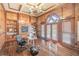 Stately home office with custom wood paneling, built-in bookshelves, and french doors at 2740 Bountiful Pl, Lawrenceville, GA 30045