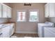 Bright laundry room with built in cabinets, countertop, sink, and like-new washer and dryer at 2740 Bountiful Pl, Lawrenceville, GA 30045