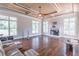 Spacious living room featuring a decorative fireplace, trey ceiling with fan, and beautiful hardwood floors at 2740 Bountiful Pl, Lawrenceville, GA 30045
