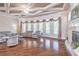 Bright living room featuring hardwood floors, fireplace, large windows, coffered ceilings, and stylish gray sofas at 2740 Bountiful Pl, Lawrenceville, GA 30045