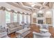 Spacious living room with coffered ceiling, fireplace, hardwood floors, and large windows with curtains at 2740 Bountiful Pl, Lawrenceville, GA 30045