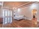 Spacious main bedroom featuring a fireplace, wet bar, hardwood floors, large windows, and decorative lighting at 2740 Bountiful Pl, Lawrenceville, GA 30045