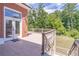 Outdoor entertaining space featuring a tiled deck, wooden railing and steps, leading to lush green yard at 2740 Bountiful Pl, Lawrenceville, GA 30045