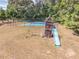 Outdoor wooden playset on a spacious lawn, featuring a swing set, slide and playhouse for Gathering fun at 2740 Bountiful Pl, Lawrenceville, GA 30045