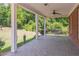 Covered porch with white columns, ceiling fan, swing, and views of the surrounding landscape at 2740 Bountiful Pl, Lawrenceville, GA 30045